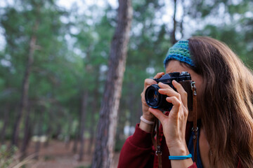 The girl takes pictures with the camera. girl having fun traveling with vintage camera