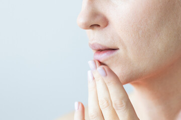 Woman gently touching her lips. Woman with nasolabial wrinkles, problem dry skin and with big pores...