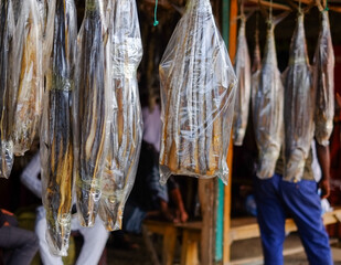 dried fishes hanging in a market