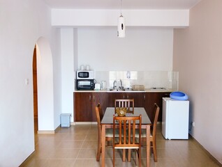 A room in an apartment with a kitchen and dining table