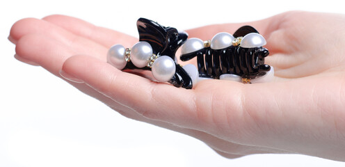 Pearl hair clip hairpins beauty trendy accessories in hand on white background isolation