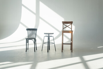 Bar stool on a white cyclorama with reflections from the window.