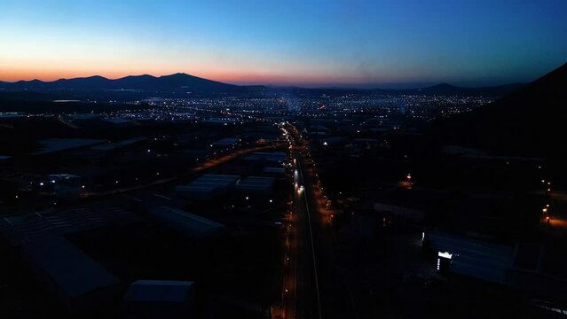 Aerial View of Factories with Evening Traffic on City Roads