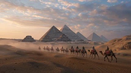 Fototapeten A scenic view of a camel caravan silhouetted against the grand Egyptian Pyramids amidst sand dunes during a captivating sunset © Daniel