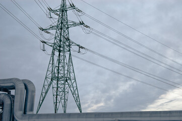 pipeline and power lines against the background of a gray sky