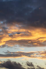 Fototapeta na wymiar Bright yellow clouds at sunset in sky