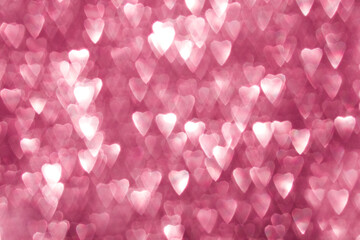 Valentine's Day background made of out-of-focus bokeh in the shape of hearts.