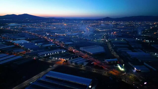 Aerial View of Factories with Evening Traffic on City Roads