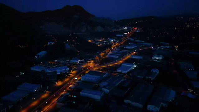 Aerial View of Factories with Evening Traffic on City Roads