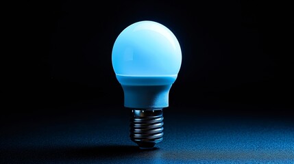 A single LED bulb shines with a cool blue light, standing out in stark contrast to the dark, shadowy background, symbolizing ideas and innovation.