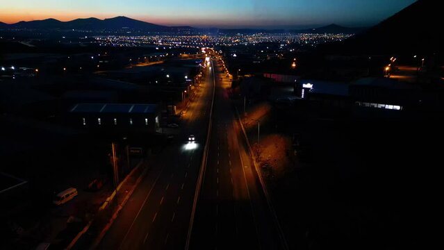 Aerial View of Factories with Evening Traffic on City Roads