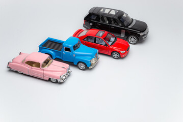 Buying car. Toy cars on white background top view copyspace