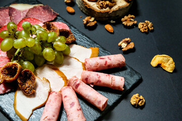 Platter of Assorted Meats, Cheeses, Nuts, and Grapes