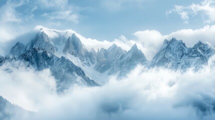 alpine landscape with peaks covered by snow and clouds