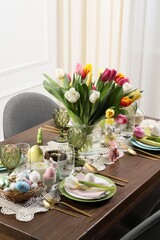 Obraz na płótnie Canvas Festive table setting with beautiful flowers. Easter celebration