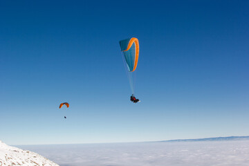 Two paragliders. Paragliding in Auvergne. paragliding flight in the mountains in France....