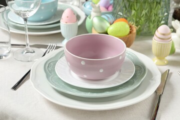 Easter celebration. Festive table setting with painted eggs.