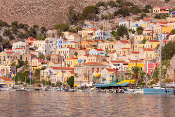 Multi-colored facades of houses in the Greek village Symi on a sunny day - 748905372