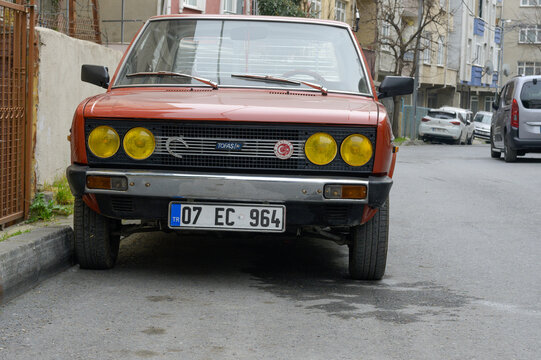 Istanbul, Turkey - March 1, 2024: Orange car Tofas Murat 131 in the city street.