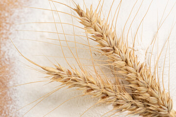 Wheat spikelets on wheat flour.