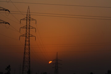 Finding beauty in the mundane: silhouette of a wire pole against the canvas of a vibrant sunset