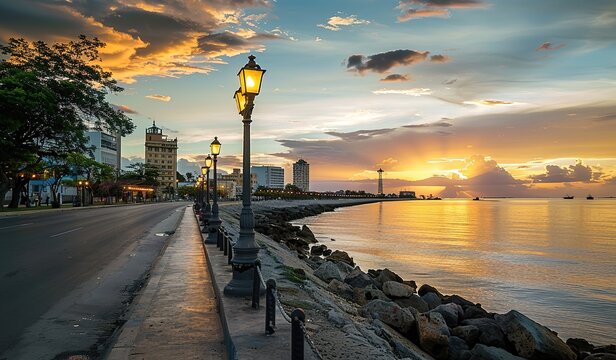 Golden hour of tranquility: a picturesque view of the coastal cityscape illuminated by the warm glow of sunset, with street lamps illuminating the road