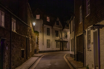 Street in Rye, Image shows a narrow street in the historic town at night time, illuminated by...