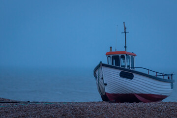 Fishing boat on a shingle beach along the British coast, Image shows a fishing boat in good...