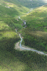 Fototapeta na wymiar Lake Clark National Park in Alaska. Emerson Creek and Falls. Aerial view of spruce trees, rugged mountains near Twin Lakes.