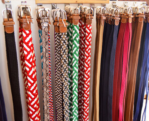 Colorful braided belts. Male belt. Ubrique crafts. Display stand with belts in a store in Ubrique, fashion from Spain
