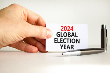 2024 global election year symbol. Concept words 2024 global election year on beautiful white paper. Beautiful white background. Voter hand. Business 2024 global election year concept. Copy space