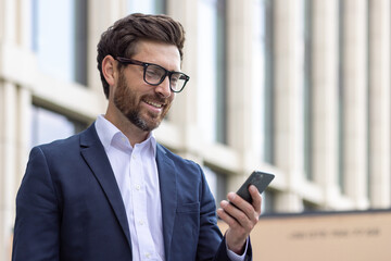 Close-up photo of a smiling young man businessman, lawyer, politician wearing a suit and glasses...