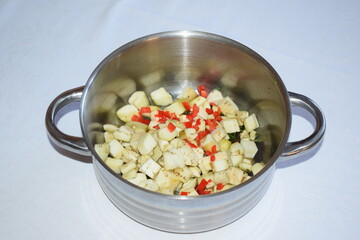 red and orange paprika with green basil leaves