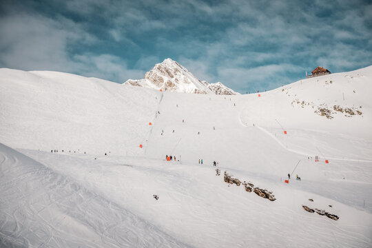 Ski resort in winter Alps. Skiers ride down the slope. Tux, Hintertux, Austria.