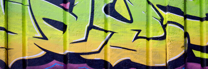 Colorful background of graffiti painting artwork with bright aerosol outlines on wall. Old school...