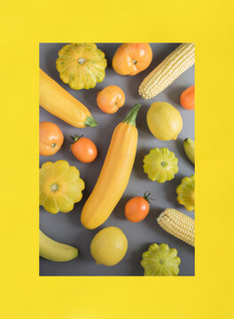 Yellow vegetable and fruit on the gray and yellow background. Close-up. Top view.