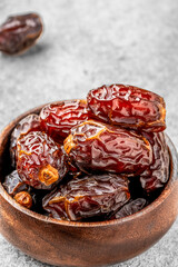 Dried delicious date fruit on vintage stone background