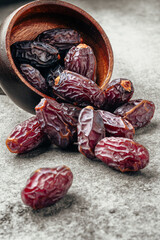 Dried delicious date fruit on vintage stone background