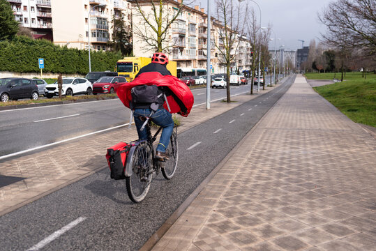Cycling along the bike path on a rainy and windy day