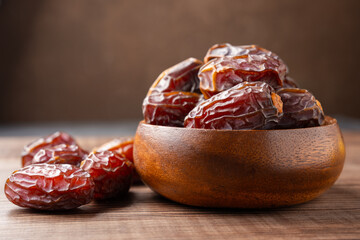 Dried delicious date fruit on vintage stone background