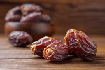 Dried delicious date fruit on wooden background