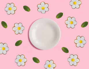 Empty white plate for text and gingerbread cookies in the shape of a daisy on the pink background....