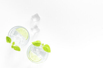 Two glasses of refreshing cocktail mojito with mint and ice, top view