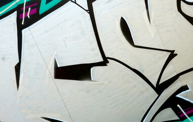 Colorful background of graffiti painting artwork with bright aerosol outlines on wall. Old school...