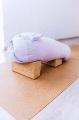 Bolster, blocks and eye pillow - props setting for relaxing yin, restorative yoga © Cristina