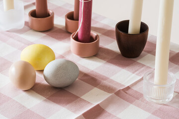 Easter place setting with candles and multi colored eggs - 748940779