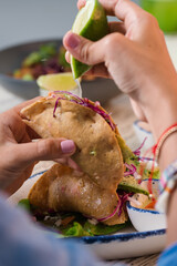 hand holding a taco
