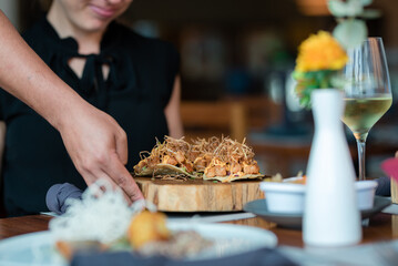 waiter serving food in restaurant