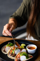 person preparing tacos