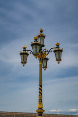 Fototapeta na wymiar Old street lamps with gold and blue in Palacio Real Madrid